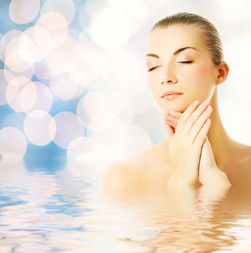 Beautiful Young Woman In Water Massaging Her Face