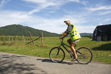 Naklejka premium Male cyclist enjoying a ride in reflective safety clothes