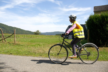 Female cyclist enjoying a ride in reflective safety clothes