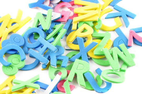 pile of letters and numbers abc and 123s on a white