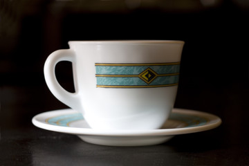 White cup on dark background close up