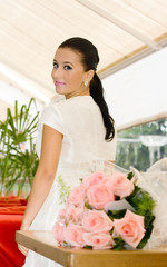 Young bride Girl and roses in cafe