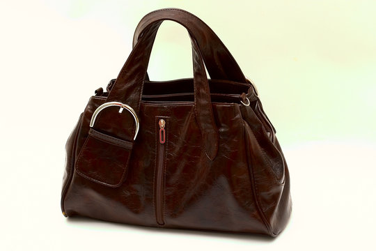 Women's leather bag cinnamic/brawn colors on a white background