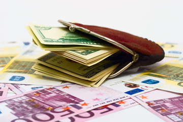 Purse full of dollars on a euro  background