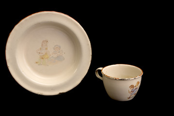 Timeworn antique child's  enamel dinner plate and cup