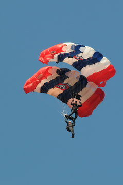various images of sky divers parachuting to earth