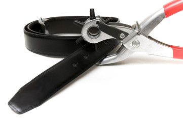 Tool used to pierce shoes and belts on a white background