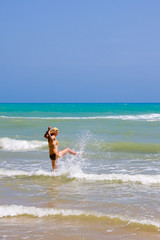 Fototapeta na wymiar a beutiful woman on the beach in Mediterranean