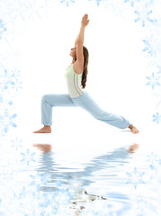 sporty girl practicing virabhadrasana warrior pose on white sand