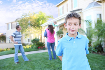 A happy family having fun outdoors in front of their home