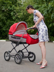 Young woman with red baby carriage