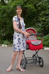 Young woman with red baby carriage