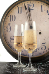 champagne in glasses with new years countdown clock