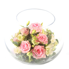 Glass bowl full with pink roses.