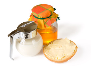 Milk, honey and bread with butter isolated on white with shadows