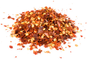 Heap of crushed chili isolated on white, macro lens used