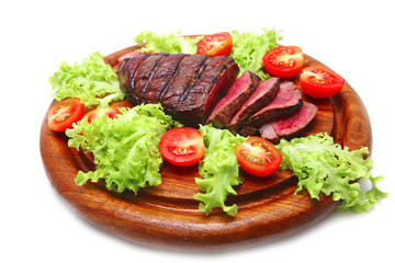 served grilled beef meat steak on wooden plate