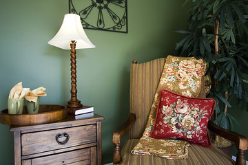 Close up on a corner of a house with a chair and nightstand