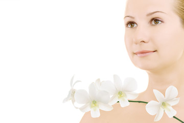 Close-up face of young woman with orchids on white background