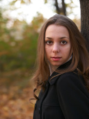 Fototapeta premium Portrait of beauty young girl in autumn forest in warm colors.