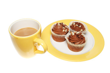 Obraz na płótnie Canvas Mug of coffee and chocolate cup cakes on a plate
