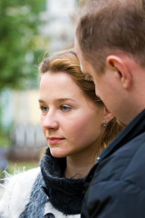 The young married couple walks in autumn park