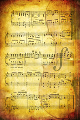 Fototapeta premium Grunge background with sheet music and a cello.
