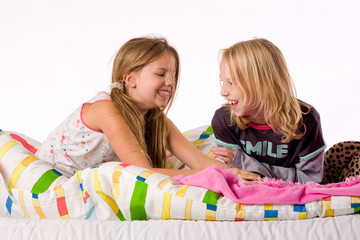 Two young children enjoying their colorful bed