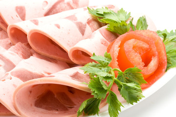 The sausage cut by slices on a dish