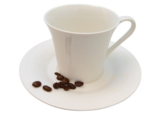 white cup and some coffee beans near it