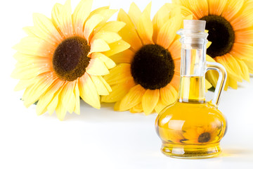 Sunflower and vegetable oil in a bottle on a white background