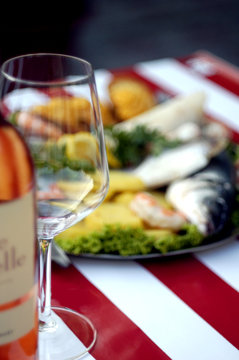Wine and Fish on Plates on red stripes table