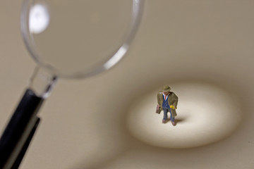 Businessman under magnifying glass