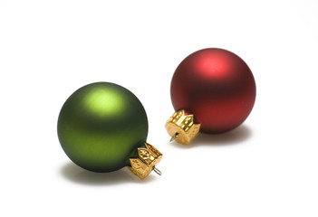 Green and red christmas ornaments on white background