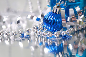 A lovely blue baubles on a mirror  surface