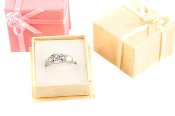 beige box holds a diamond engagement ring