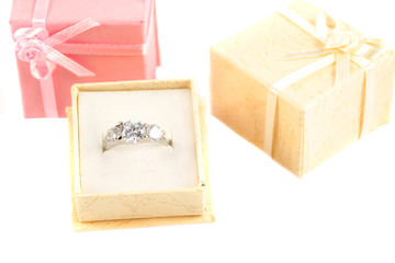 beige box holds a diamond engagement ring