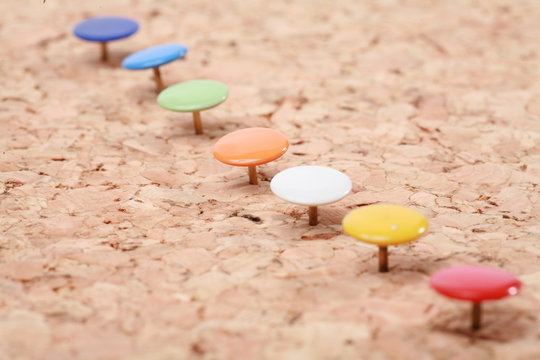 a pinboard with thumtacks on it...........