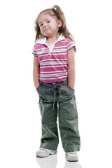 Fototapeta premium Little girl with rascal expresion, with her hands in her pokets