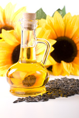 Sunflower and vegetable oil in a bottle on a white background