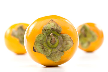 Fresh appetizing persimmon on a white background