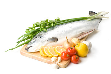 Fresh raw salmon with vegetables on a white background