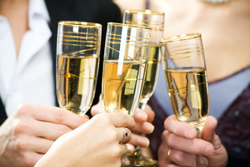 Hands holding the glasses of champagne making a toast