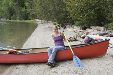 Young woman in a canoe holding the paddle, Canada