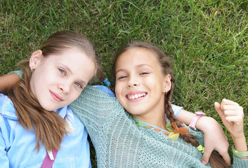 Two preteen girl having fun outdoors