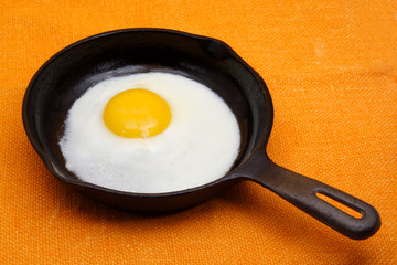 egg in a black cast iron pan