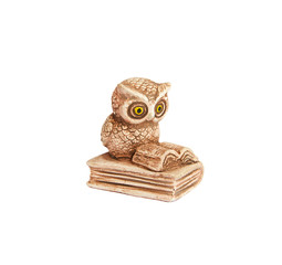 Figurine of a little owl sitting on a book and reading
