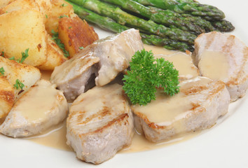 Pork medallions in apple sauce with sauteed potatoes