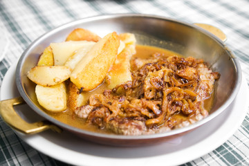 Tasty beefsteak closeup. Roast meat with potatoes.