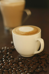 Cappuccino and coffee beans